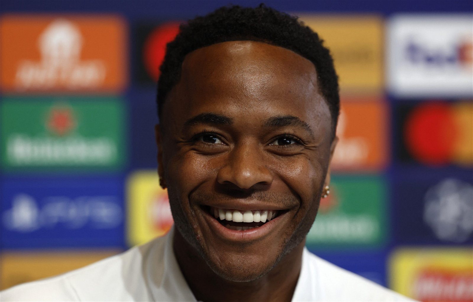 Manchester-City-star-Raheem-Sterling-smiles-in-a-press-conference-ahead-of-Champions-League-game-against-Real-Madrid