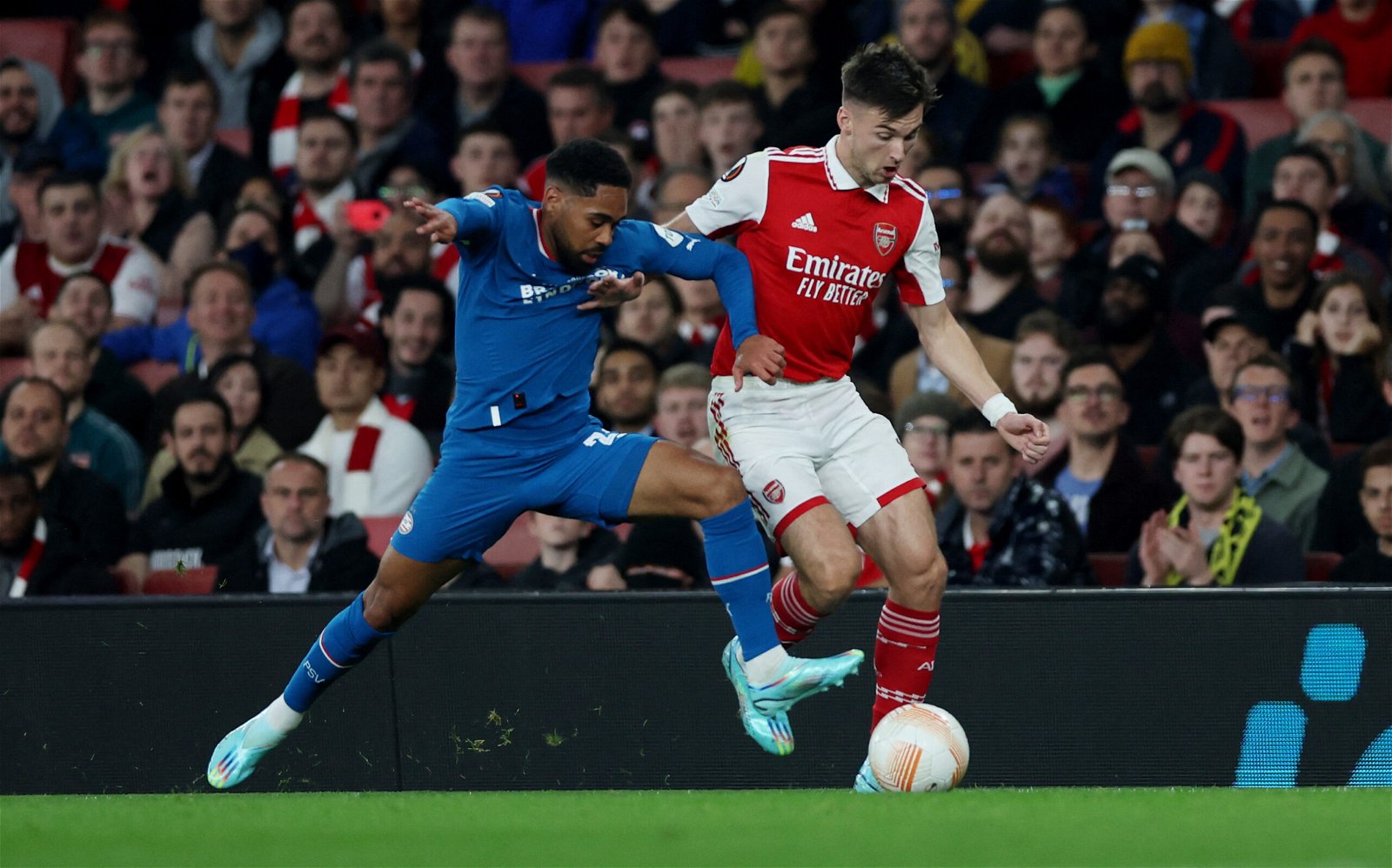 Arsenal's Kieran Tierney is challenged by Philip Mwene
