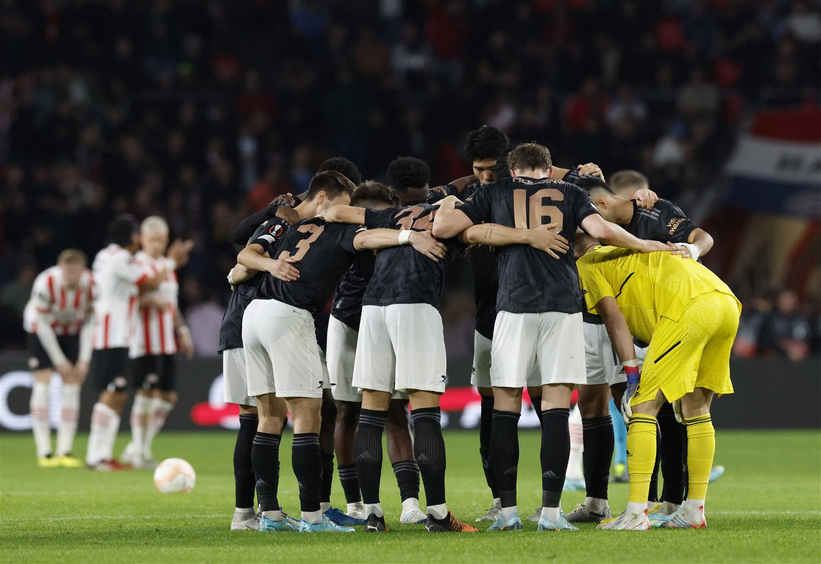 Arsenal's players huddle during their Europa League clash against PSV